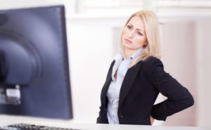 woman with back pain in the workplace